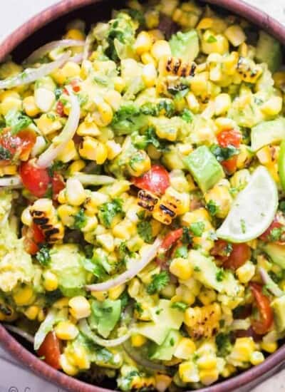 avocado corn tomato salad in wooden salad bowl