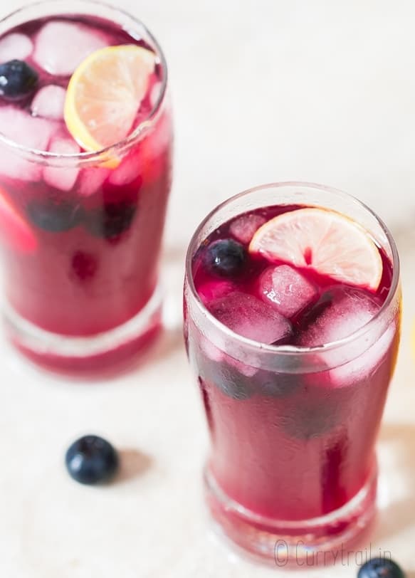 blueberry lemonade served in 2 glasses