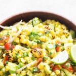 avocado corn salad in a wooden bowl with text.