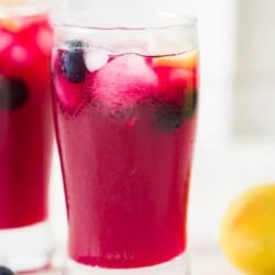 icy cool refreshing lemonade with blueberries served in two glasses
