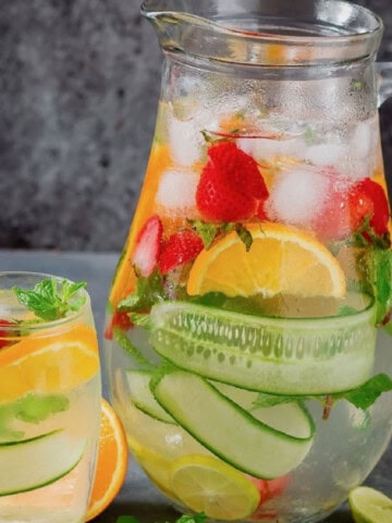 fruit-infused water in a pitcher and glass.