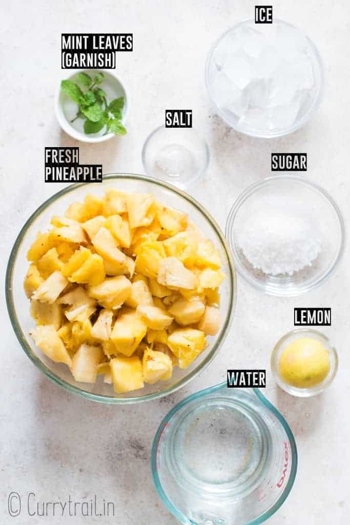 all ingredients for fresh pineapple juice on white board