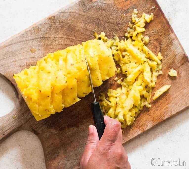 removing pineapple eyes using sparing knifes