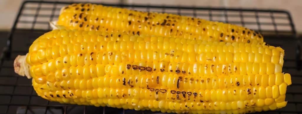 grill two sweet corn on BBQ.