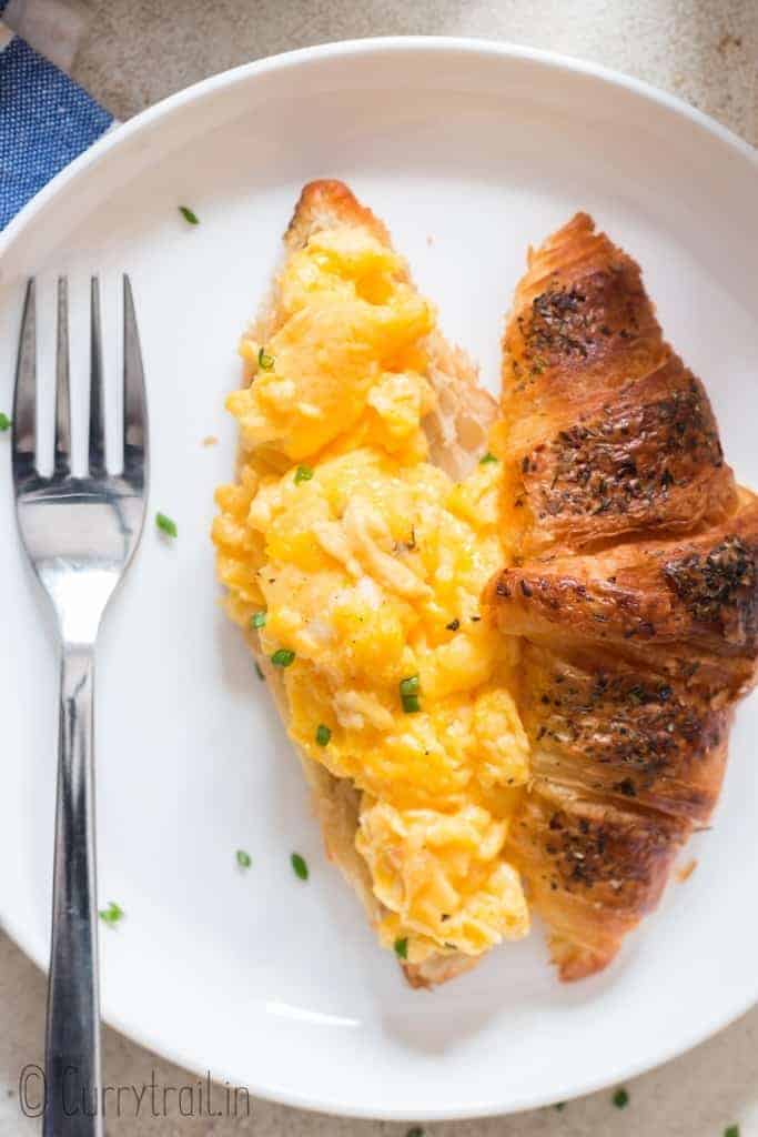 creamy egg scramble on croissant bread