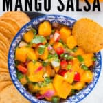 mango salsa with nachos in blue ceramic bowl with text