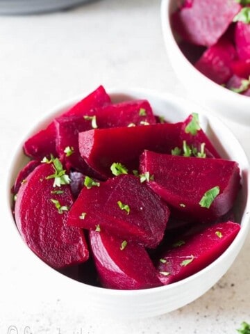 chopped soft tender beets cooked in instant pot in white ceramic bowls