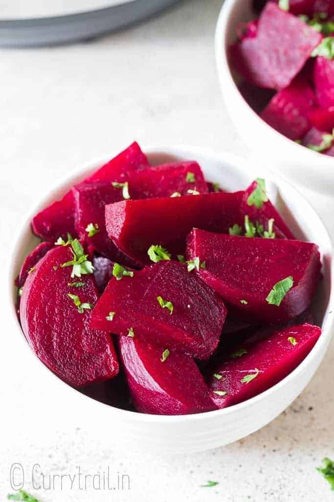 chopped soft tender beets cooked in instant pot in white ceramic bowls