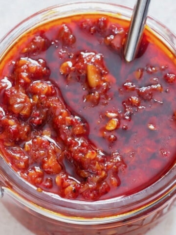 Close-up view of spicy schezwan sauce in a jar.