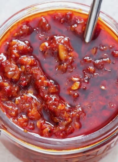 Close-up view of spicy schezwan sauce in a jar.