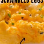 fluffy egg scramble on white plate with text overlay