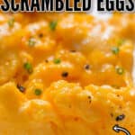 creamy, fluffy scrambled eggs on white plate with text
