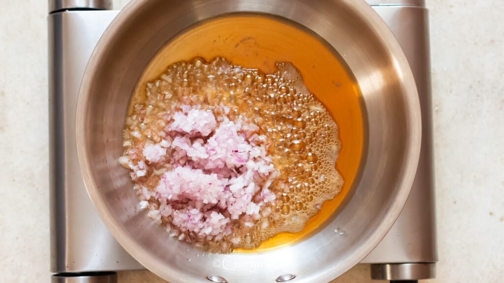 sauté shallots in sesame oil in a skillet.