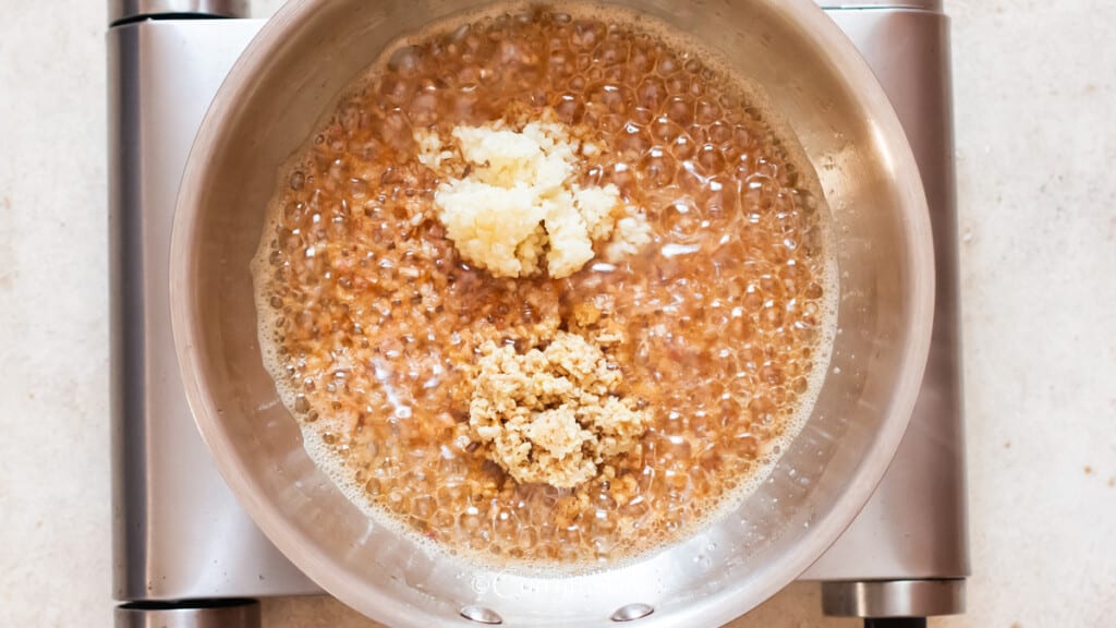 saute minced garlic and ginger along with shallots in a skillet.