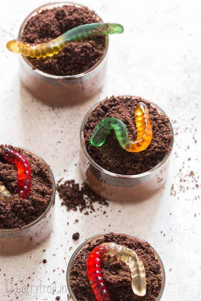 4 cups of OREO chocolate pudding with gummy worms on top