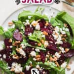 beet and feta salad with arugula on white plate with text