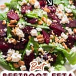 beet and feta salad with arugula on white plate with text