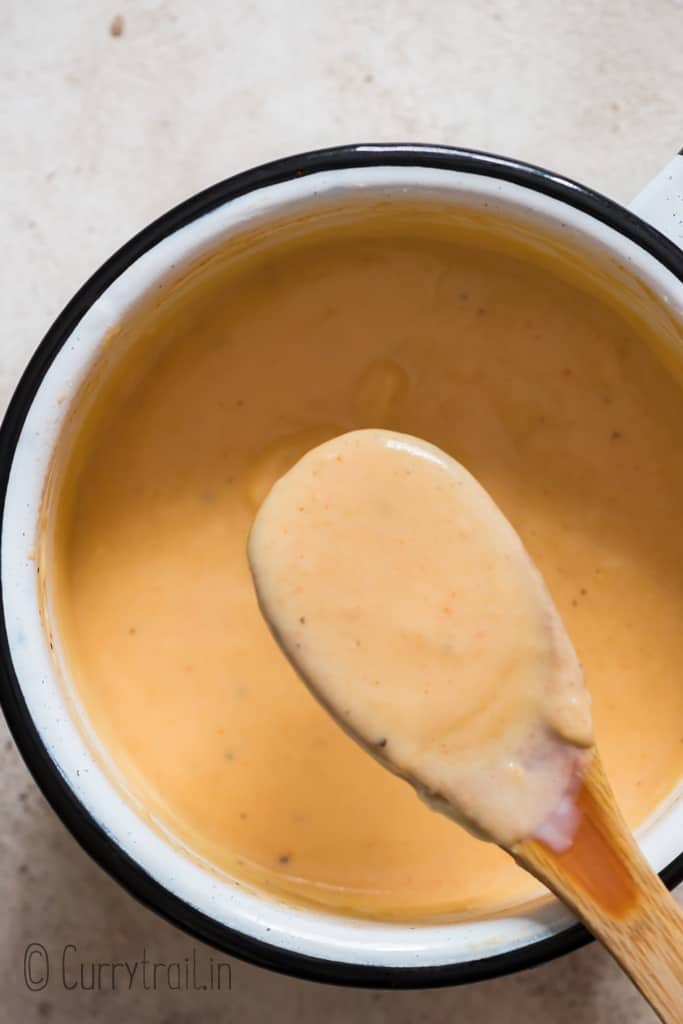 silky spicy cheese sauce in a saucepan for nachos.