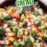 the best broccoli salad in wooden salad bowl with text