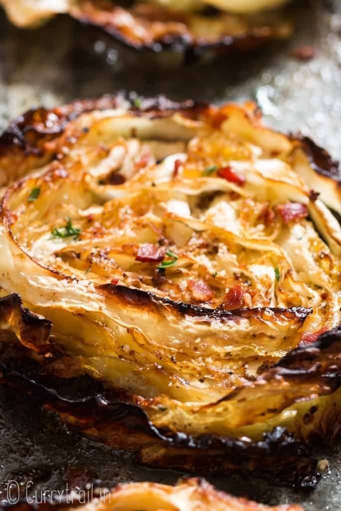 healthy oven roasted cabbage with bacon and Parmesan on baking tray.