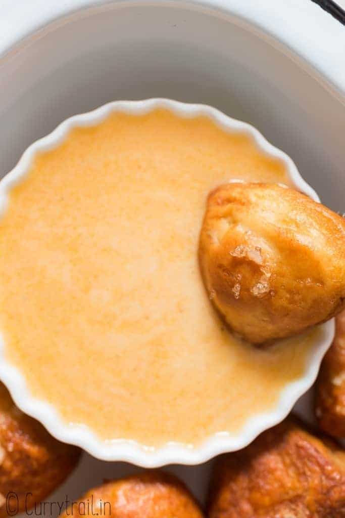 cheese sauce in small bowl with homemade pretzels