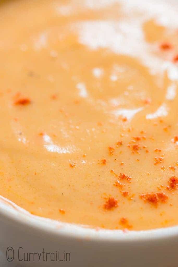 close up of spicy nacho cheese sauce served in small bowl