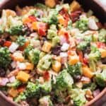 healthy broccoli salad in wooden bowl with napkin on side