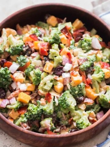 healthy broccoli salad in wooden bowl with napkin on side