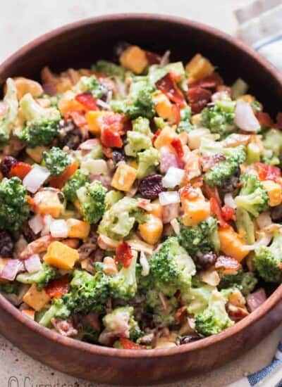 healthy broccoli salad in wooden bowl with napkin on side