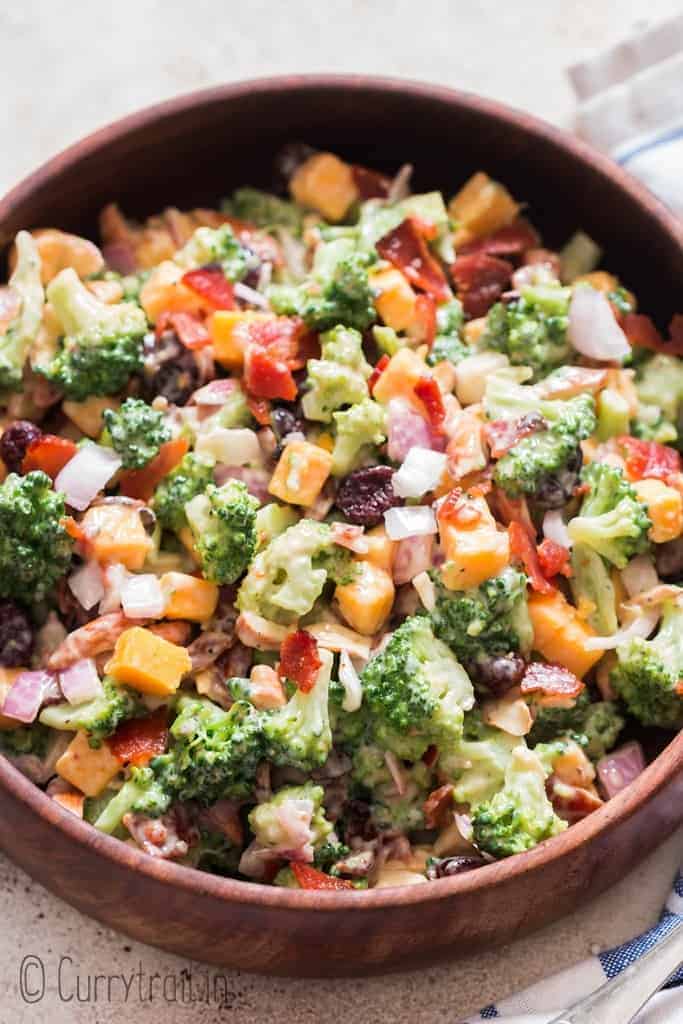 healthy broccoli salad in wooden bowl with napkin on side