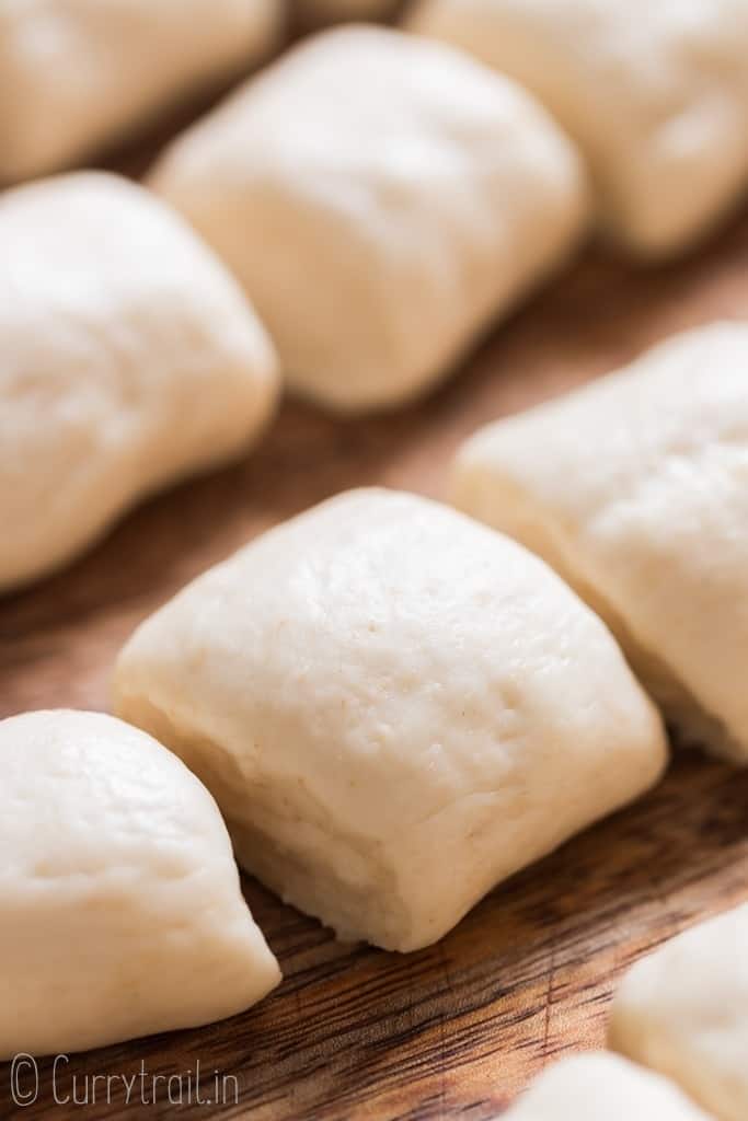 pretzel dough before baking on wooden board