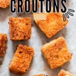 baked homemade croutons on baking tray with text