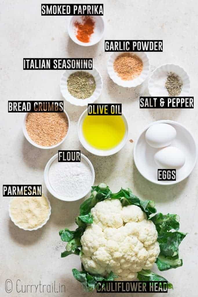 all ingredients to make oven roasted cauliflower popcorn on a board