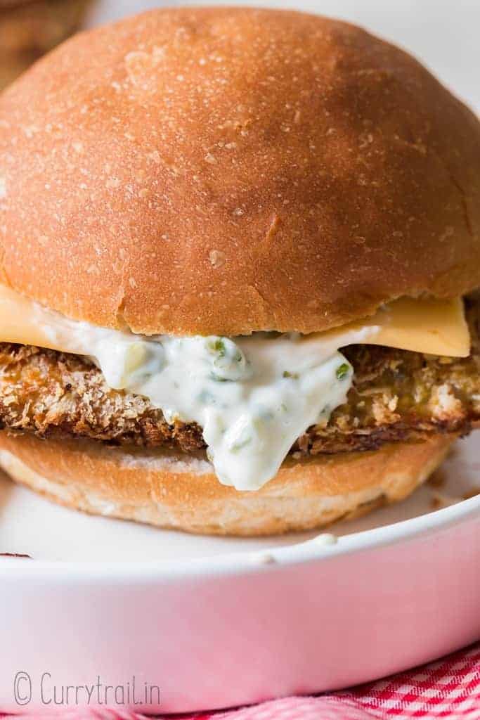baked filet-o-fish burger on white plate with red napkin below