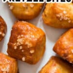 homemade soft pretzel bites on white plate with cheese sauce with text overlay