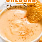 cheddar cheese sauce served in small bowl with nachos with text overlay