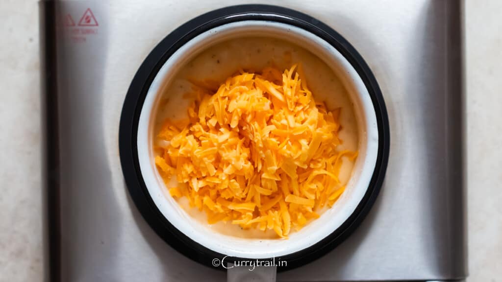 sharp cheddar cheese is added to the saucepan to make the sauce.