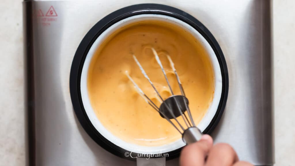 sharp cheddar cheese is added to the saucepan to make the sauce.