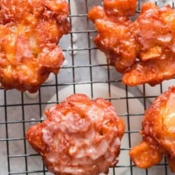 glazed fritters with apples on wire rack