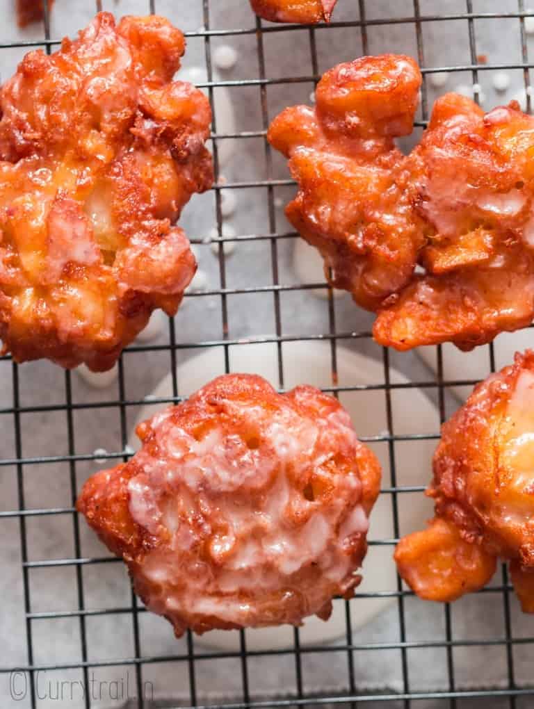 glazed fritters with apples on wire rack