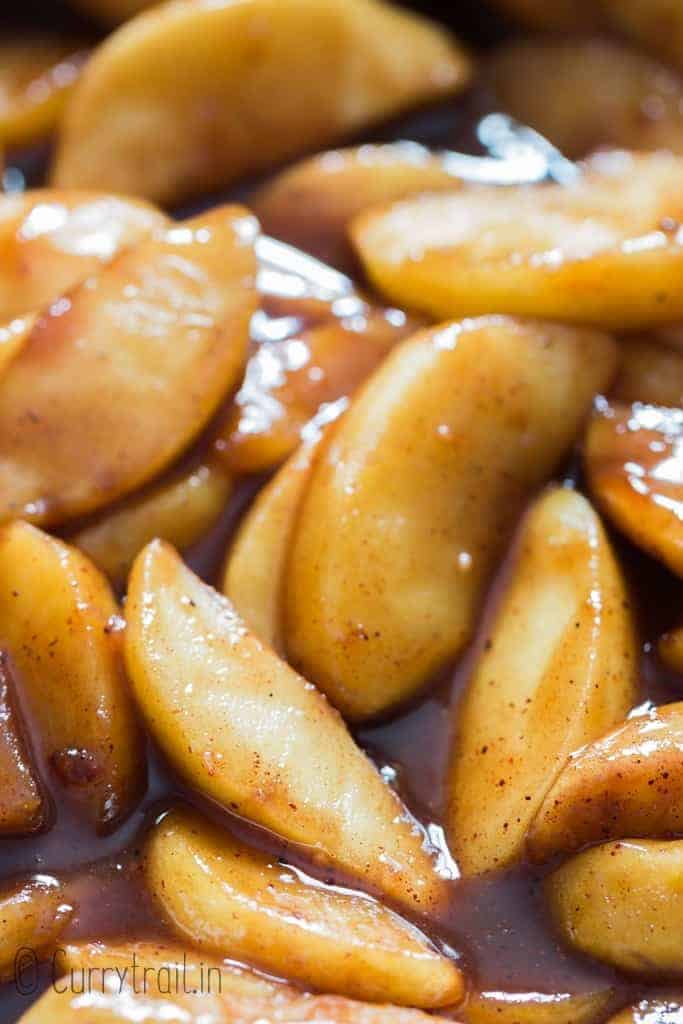 close up of apple slices cooked with cinnamon in skillet