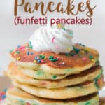 funfetti cake pancakes on white plate with whipped cream with text overlay