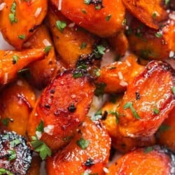 roasted glazed honey carrots with brown butter garlic in white servings dish