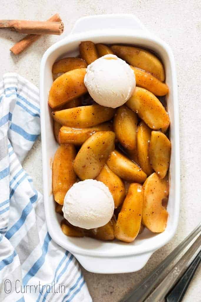 cinnamon apples with ice cream on white bowl