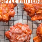 homemade glazed apple fritters on wire rack with text overlay