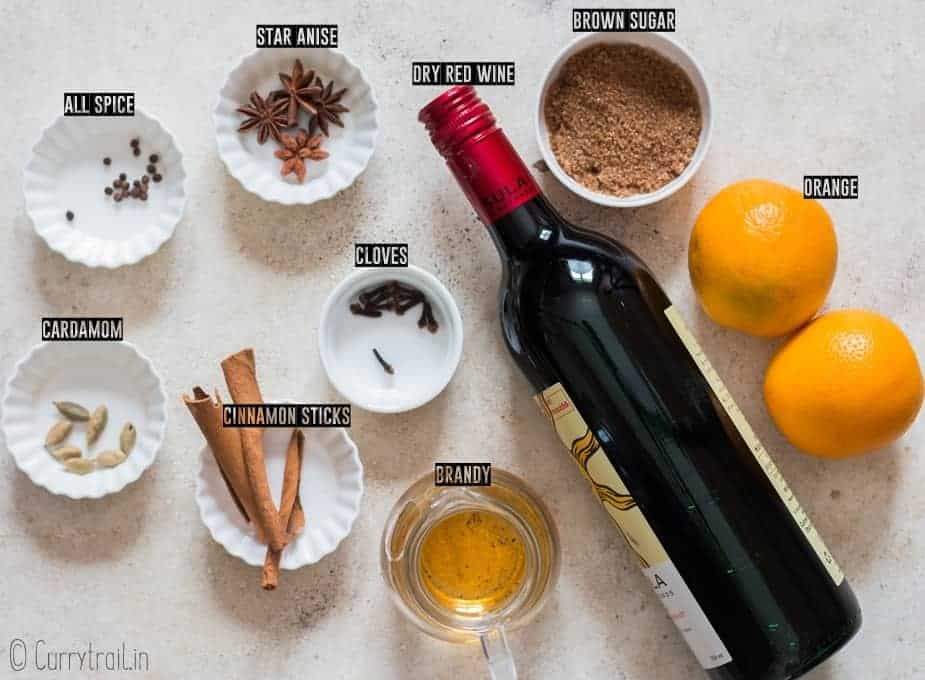 all ingredients for traditional mulled wine recipe on white board