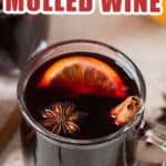 hot mulled wine in heat proof mugs with spices on sides with text