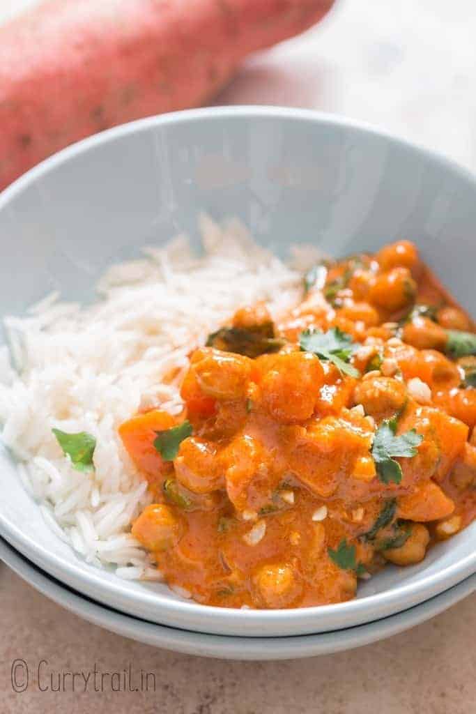 Thai sweet potato curry with long grain rice in ceramic bowl