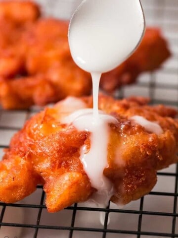 glazed fritters with apples on wire rack
