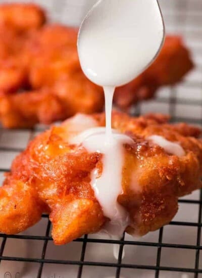 glazed fritters with apples on wire rack
